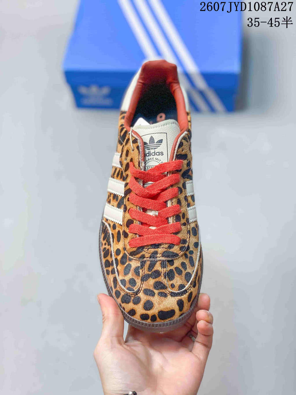 Top view showing the leopard-print toe box, red laces, white tongue, and adidas branding.