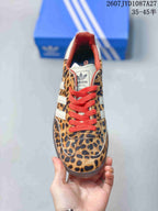 Top view showing the leopard-print toe box, red laces, white tongue, and adidas branding.