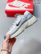 Side view highlighting the layered upper panels, dark Swoosh branding, and cream midsole.