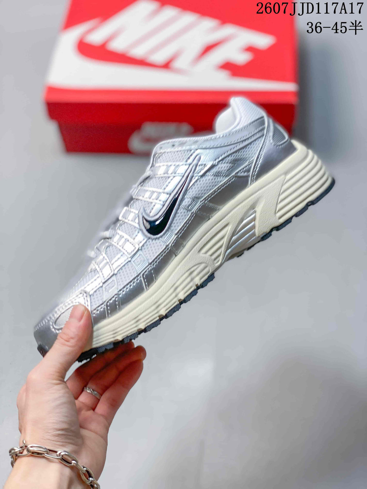 Side view highlighting the layered upper panels, dark Swoosh branding, and cream midsole.
