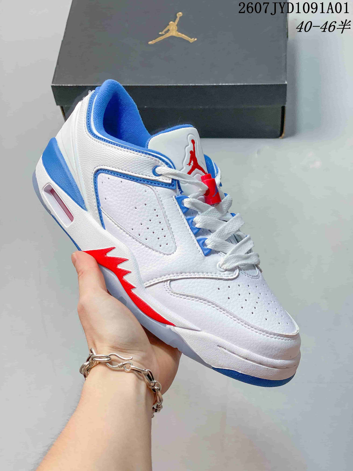 Close-up side view of a white sneaker with blue and red accents, perforated panels, and lace-up closure.