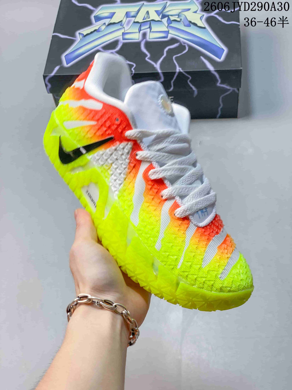 Angled view of a Nike Ja 3 basketball shoe showing the side and upper in neon yellow, orange, and white.