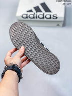 Close-up of the sneaker outsole showing a repeating geometric tread pattern.