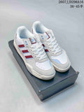 Pair of white adidas Originals Tekkira Cup sneakers with red and light blue accents displayed on a shoebox.