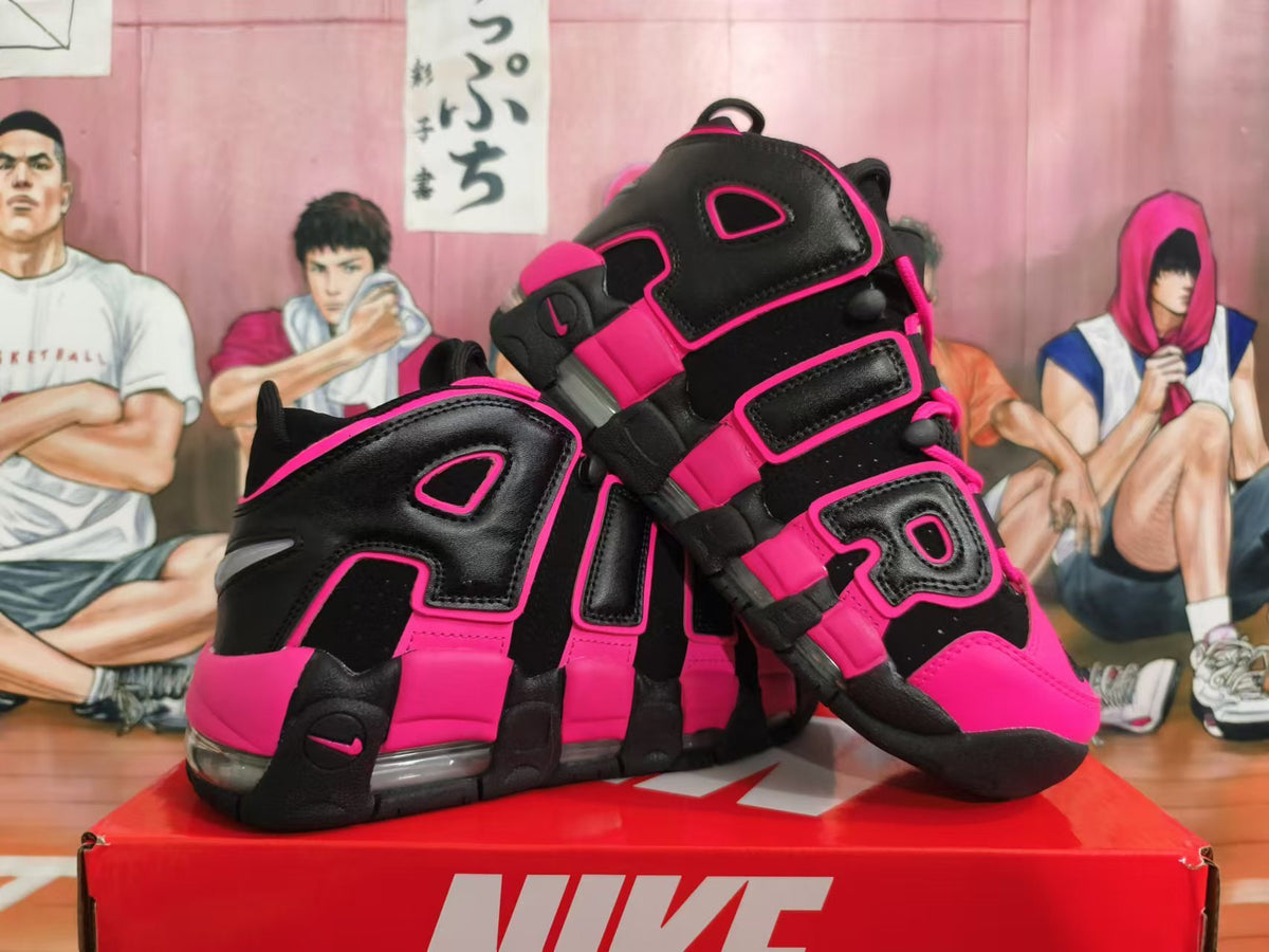 Pair of black and bright pink Nike sneakers displayed from the side