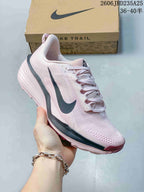 Angled side view of the pale pink trail running shoe