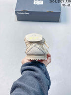 Rear view showing the padded heel and outsole edge of the cream sneaker.