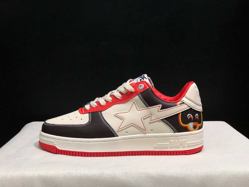 Side profile showing the white star-shaped side detail, black and white panels, red collar, and red outsole.