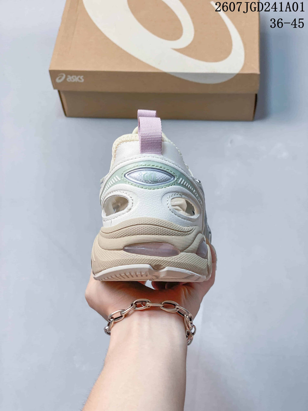 Rear view of a cream ASICS GT-2160 Breeze sneaker with a lilac pull tab