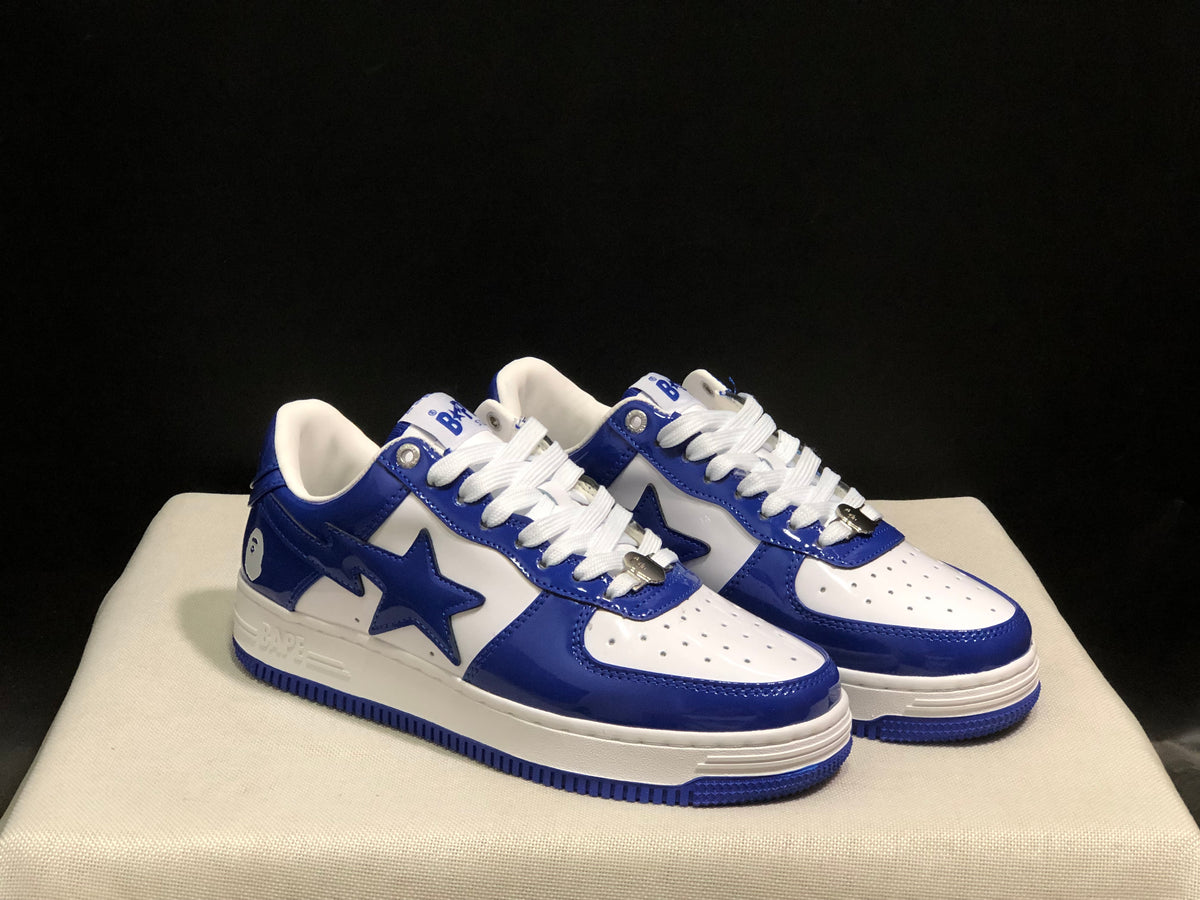Three-quarter product view highlighting the blue and white color blocking, white laces, and side star details.