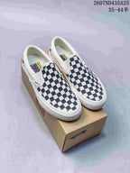 Pair of navy-and-white checkerboard low-top Vans sneakers displayed on a Vans shoe box.
