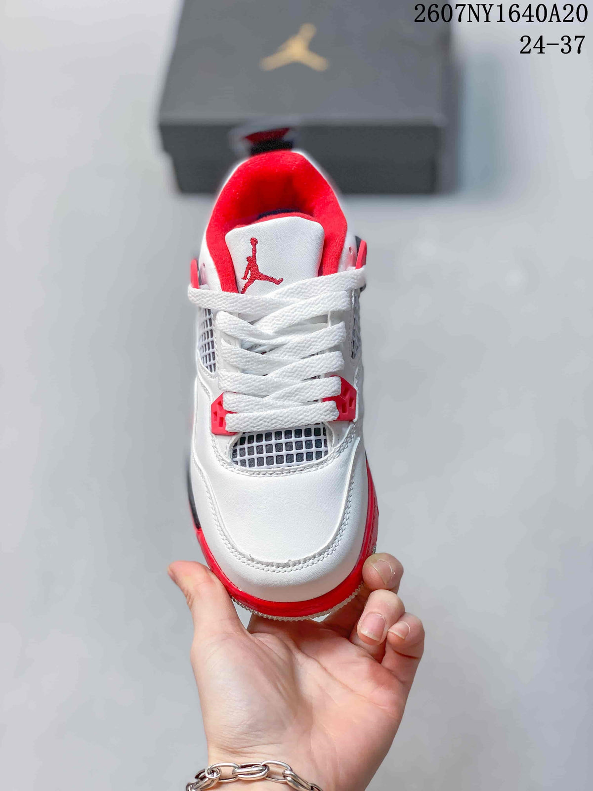 Top view showing white laces, mesh tongue-area panels, red accents, and a red-lined collar.