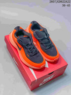 Pair of orange and black Nike Uplift SC sneakers displayed on a red Nike shoebox.