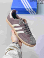 Angled side view showing the low-top silhouette, brown upper, white stripes, and gum-colored sole.
