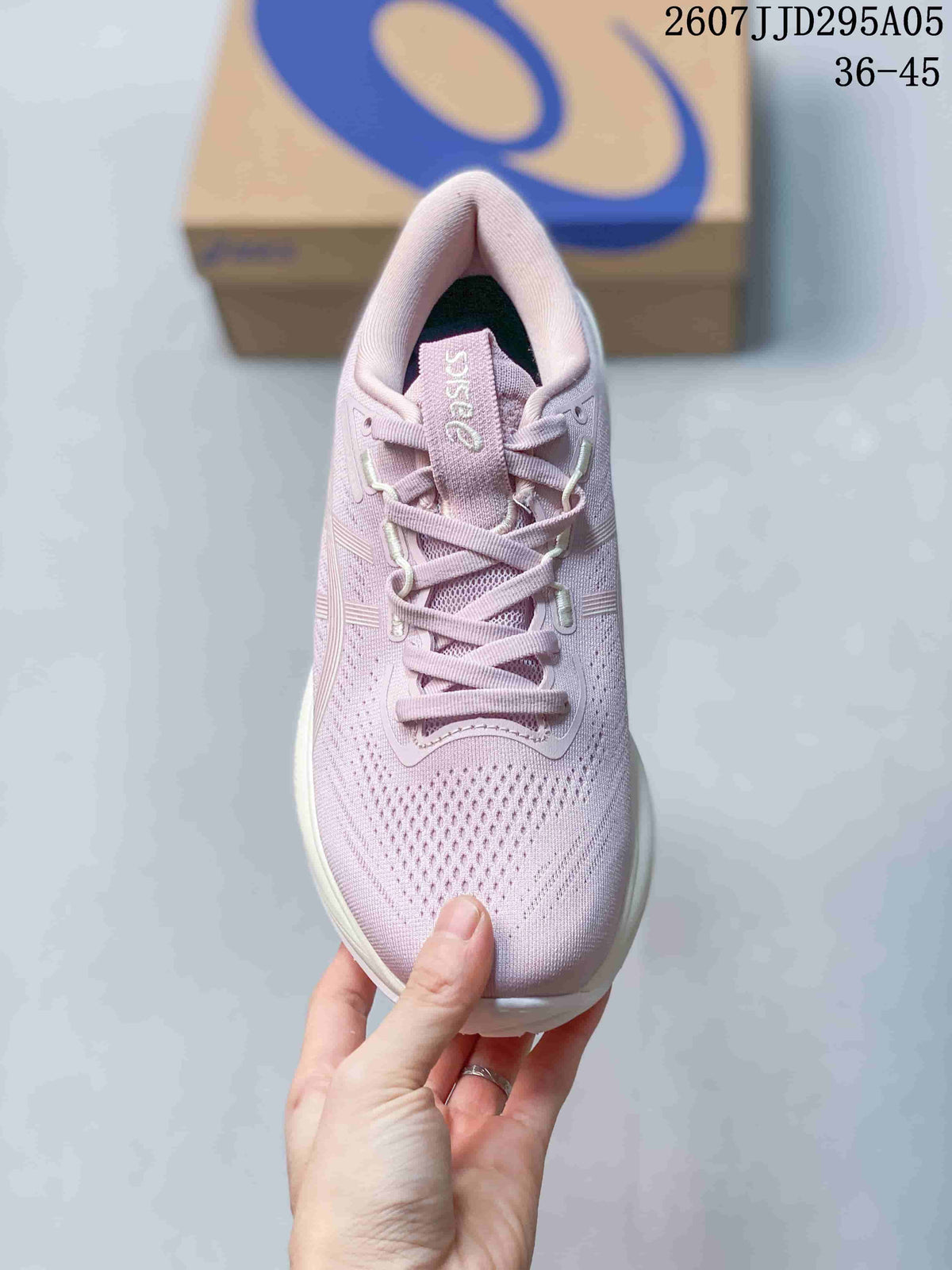 Top view of the pink lace-up sneaker showing the perforated knit toe box and padded tongue.