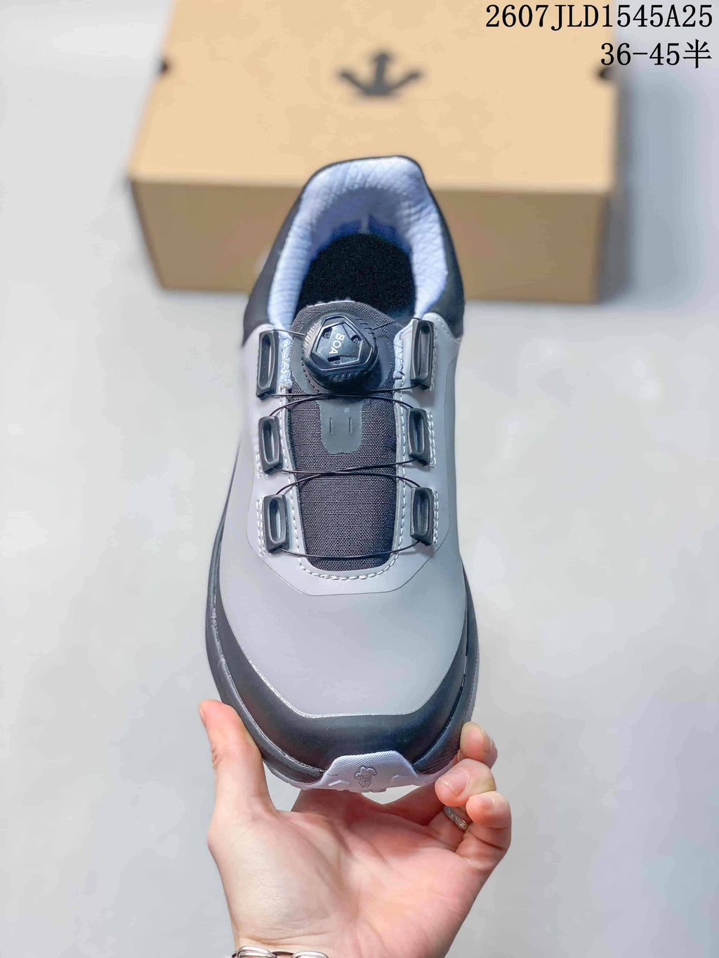 Top view of the sneaker showing the gray toe area, black tongue, BOA-marked dial, and lace guides.