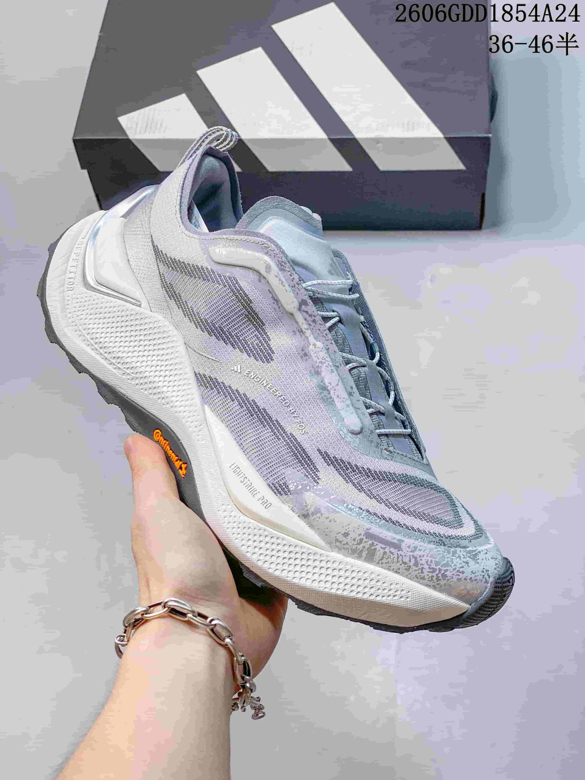 Angled side view of an Adidas Holo Peak shoe showing the upper, sculpted midsole, and outsole
