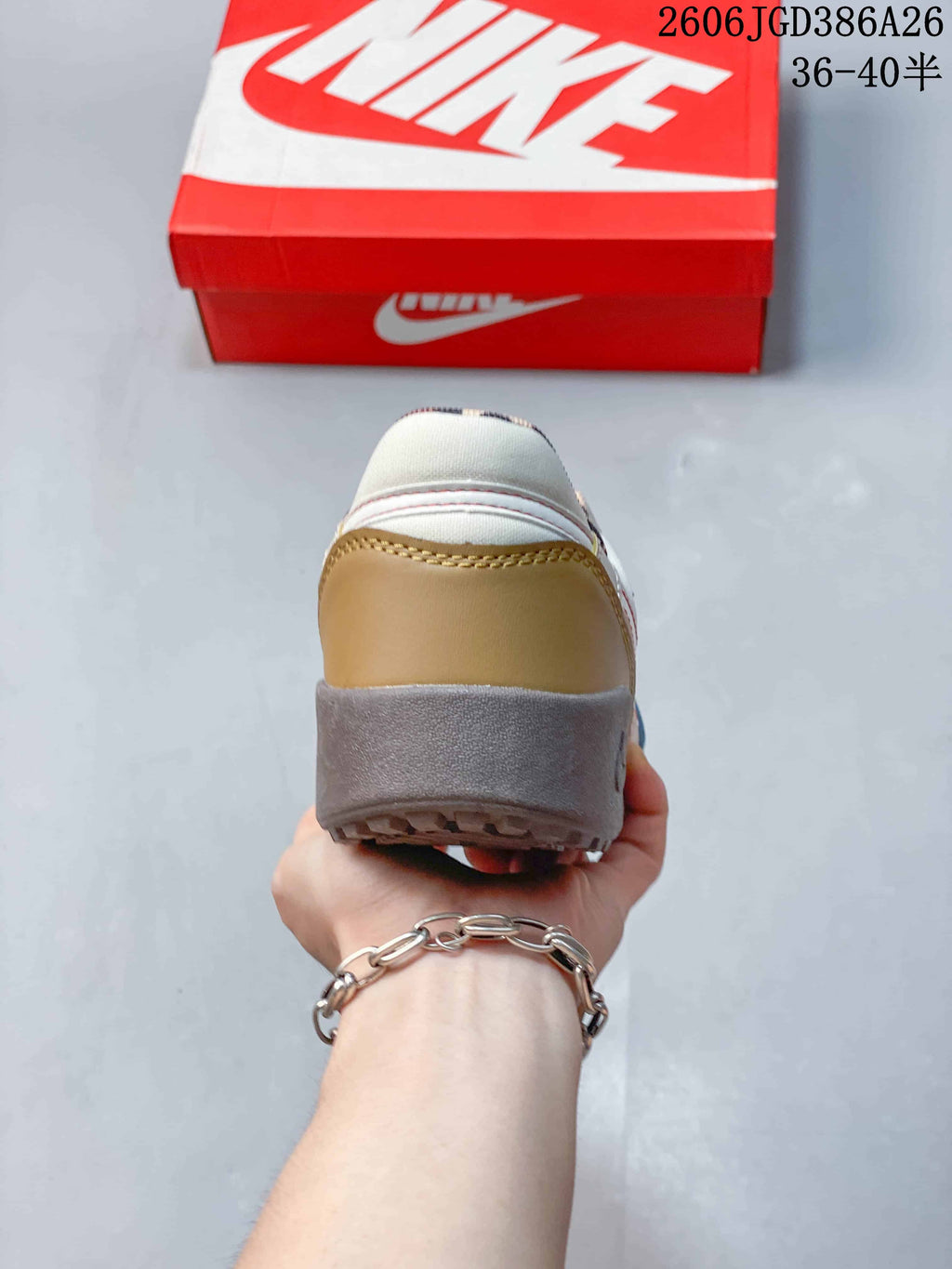 Rear view of the sneaker showing the tan heel panel, gray outsole and leopard-print collar lining.