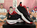 Pair of black and red sneakers shown from the side