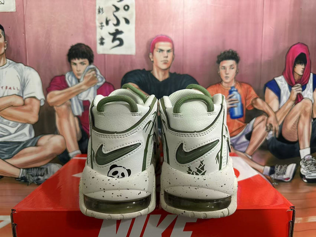 Rear view of off-white Nike sneakers with dark green accents, panda graphics, and speckled soles.