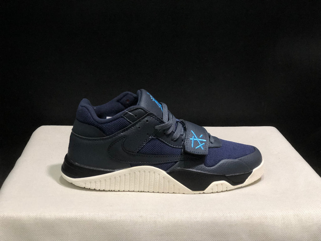 Single lateral view of the dark Jordan Jumpman Jack sneaker with navy panels, blue strap detail, and cream sole.