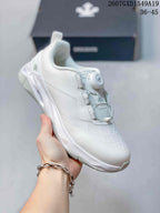 Angled side view of the white DESCENTE sneaker showing the dial closure and heel detailing.