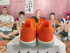 Rear view of bright orange Nike basketball shoes with white midsoles and gray translucent outsoles.