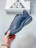 Side profile of a dark gray Nike ACG Pegasus Trail sneaker showing the Nike Swoosh, textured upper, and raised midsole.