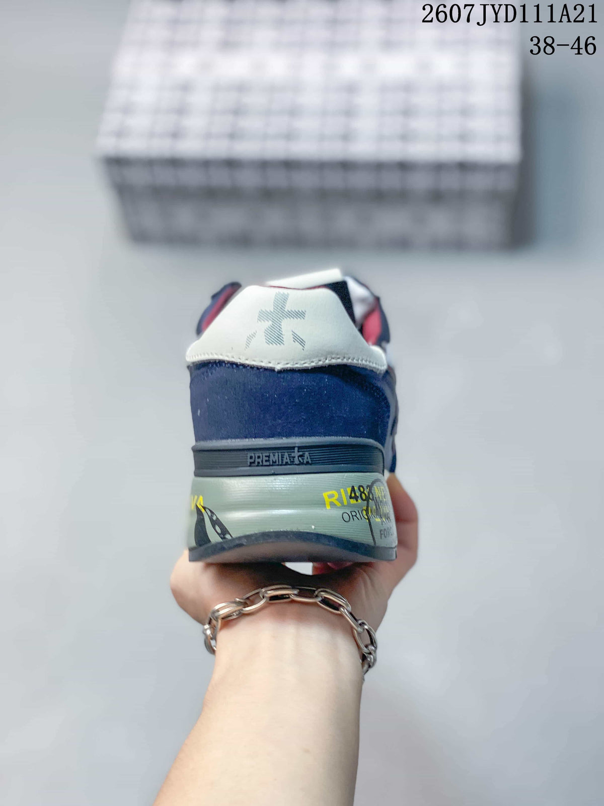 Rear view of the navy sneaker showing the white heel panel, Premiata branding and layered sole.