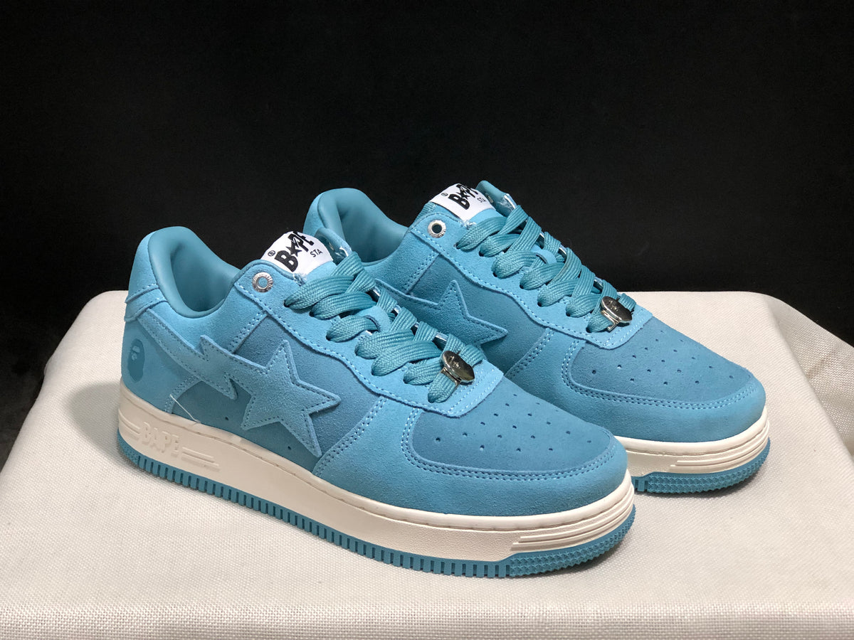Three-quarter front view of the light blue pair showing the star side panels, lace details, and off-white midsoles.