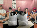 Rear view of the shoes showing contrasting heel logos and black-and-white pull tabs.