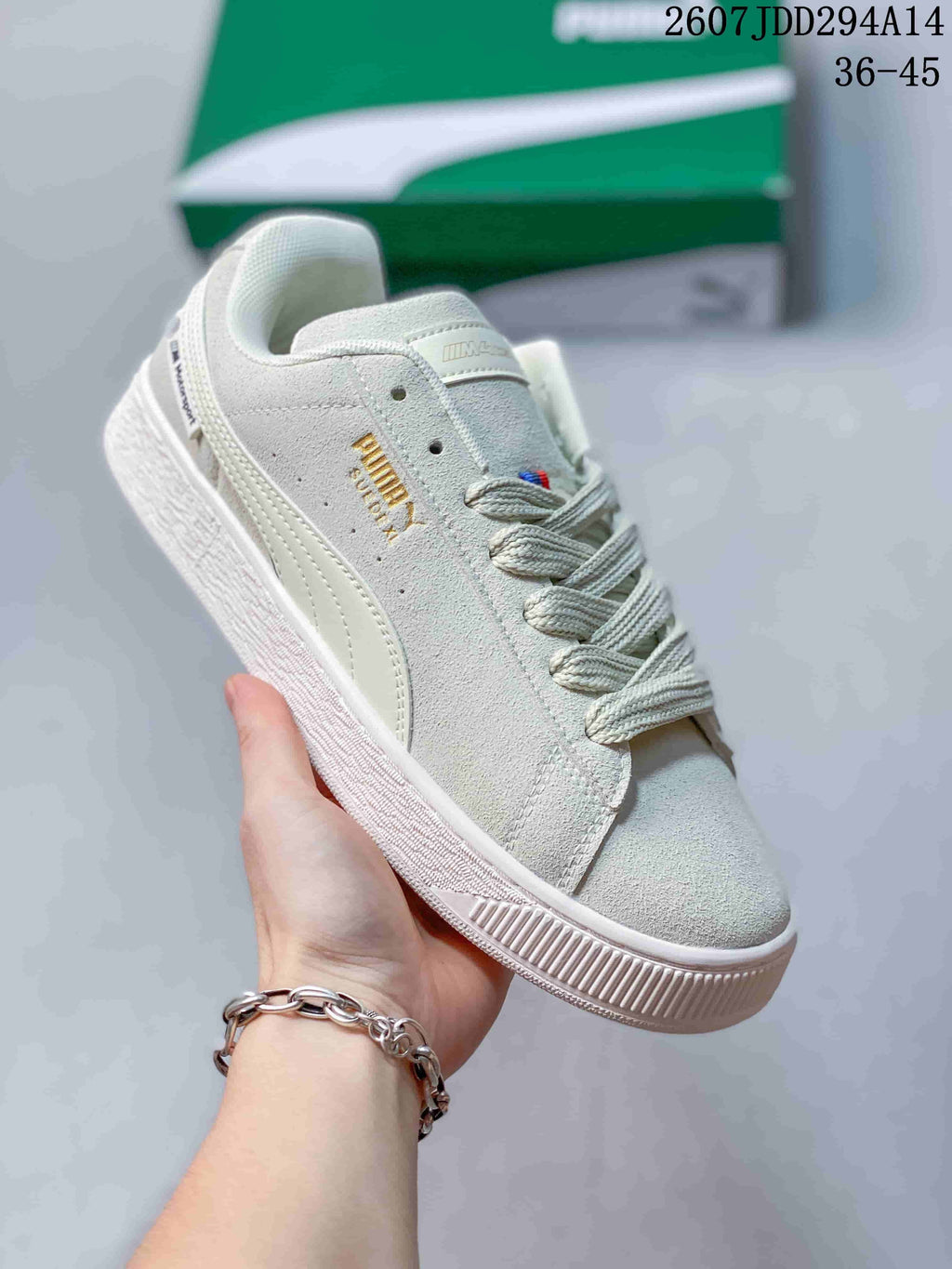 Angled side view of the white PUMA sneaker showing the side branding, formstrip and low-profile sole.