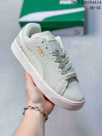 Angled side view of the white PUMA sneaker showing the side branding, formstrip and low-profile sole.