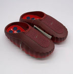 Pair of dark red slip-on sneakers showing the perforated panels, textured insoles, and side swoosh details.