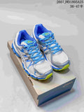 Pair of ASICS Gel-Nimbus 16 sneakers displayed on a shoebox, showing the white, blue, silver, and neon yellow color combination.