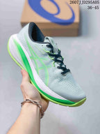 Light gray ASICS running shoe with bright green accents and a green outsole.