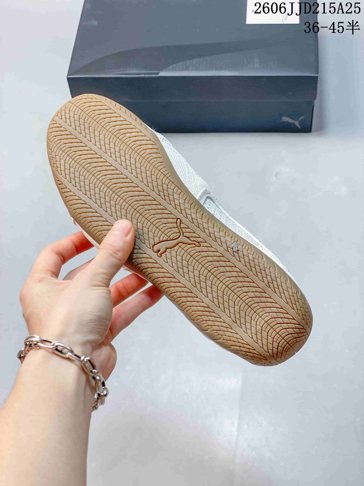 Close view of the gum-colored outsole with a repeating textured tread pattern and PUMA cat logo.