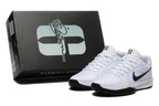 White and black basketball shoes beside a black Sabrina Jones shoe box