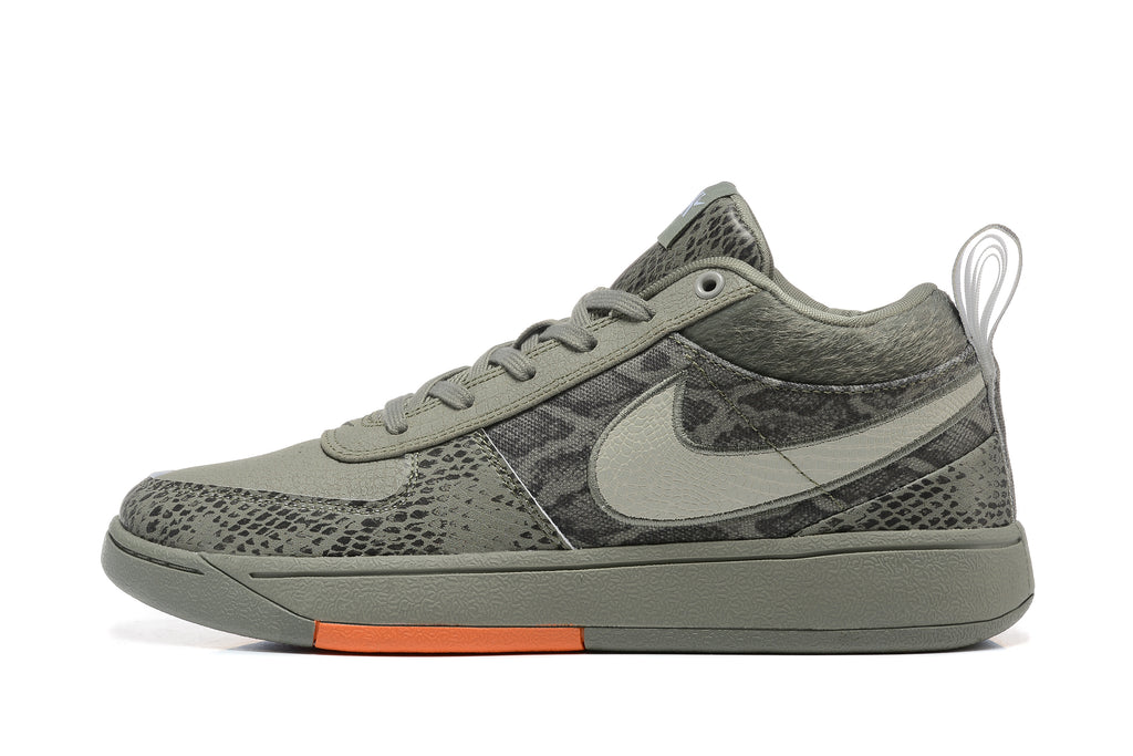 Side profile of a grey Nike Book 1 sneaker with patterned panels and orange outsole detail