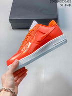 Side profile of the orange low-top sneaker with white Swoosh and midsole