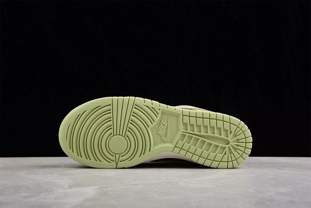 Bottom view showing the light green outsole with circular forefoot and grid-pattern traction.