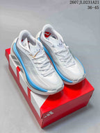 Pair of white and light blue Adidas Hyperboost Edge sneakers displayed on a red Adidas shoebox.