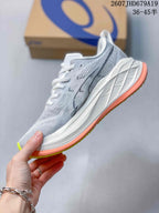 Side profile of a gray and white ASICS Superblast 2 running shoe with coral outsole edging and a sculpted white midsole.