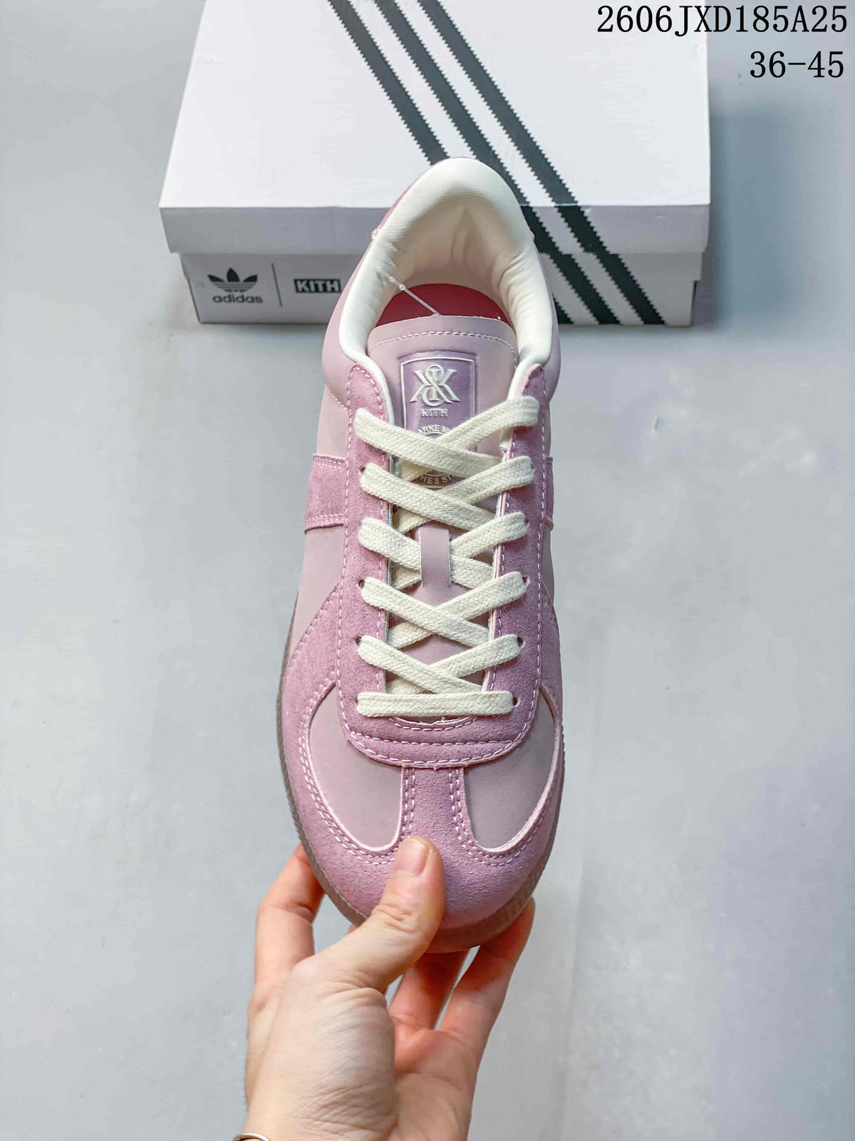 Top view of the pink sneaker with cream laces and a padded collar.