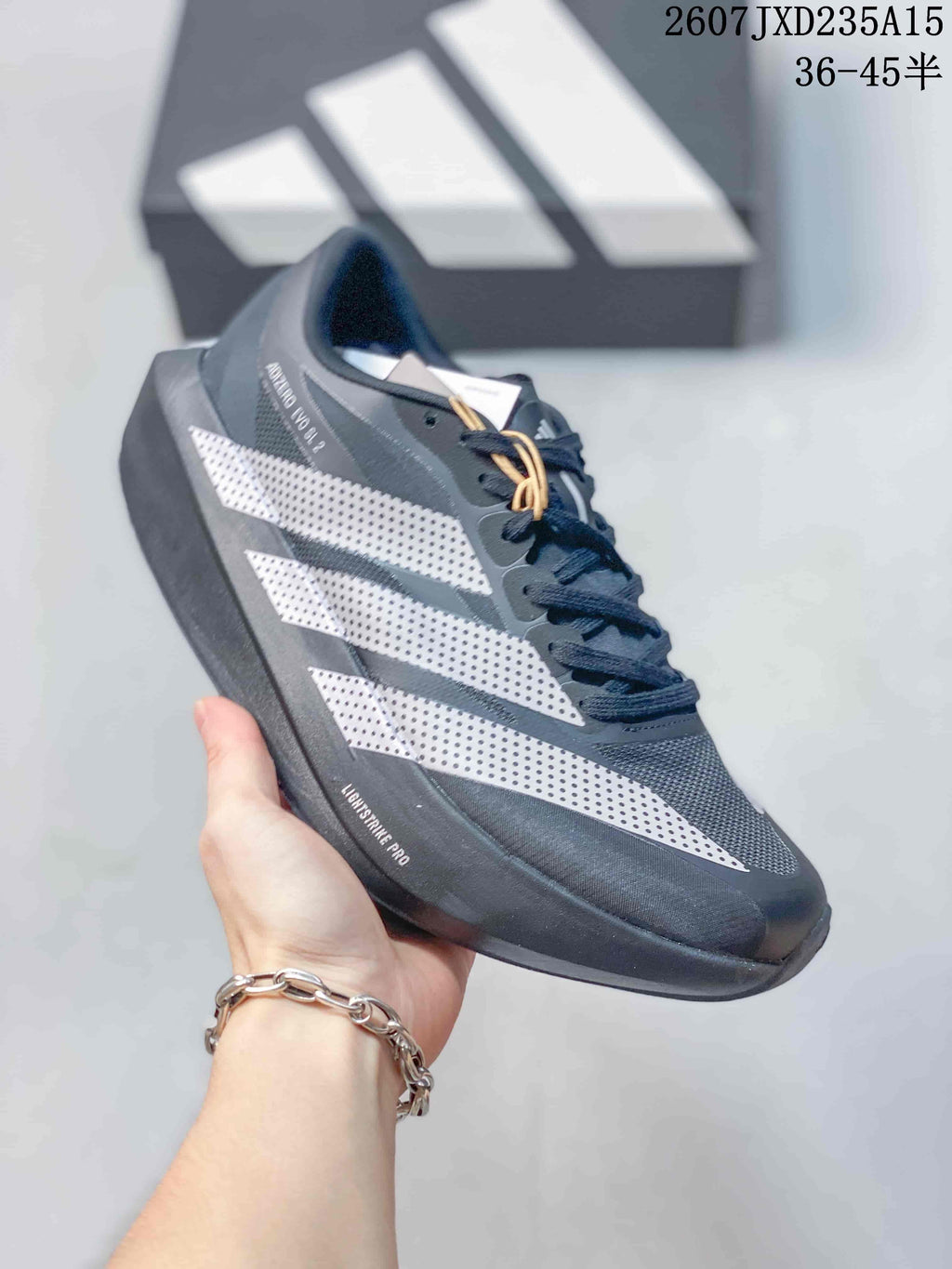 Side view showing the Adizero Evo SL 2 text, perforated white stripes, and layered sole.