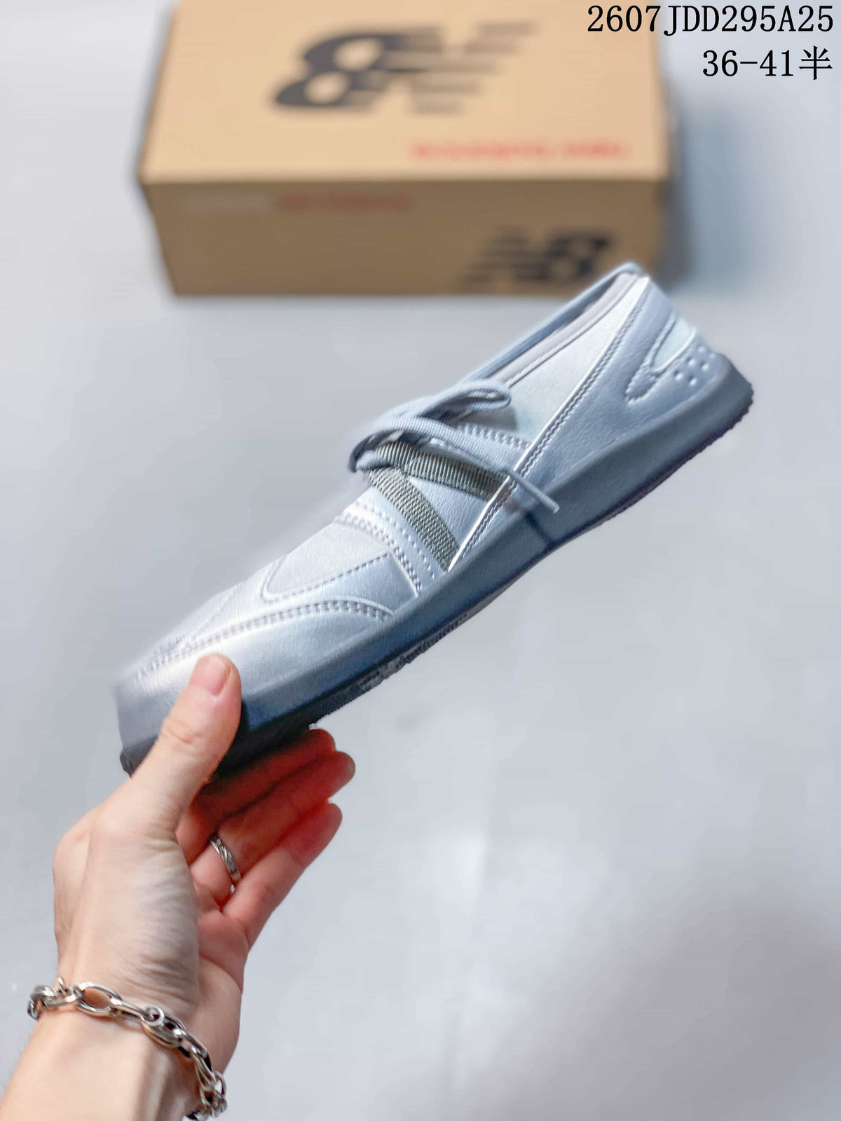 Side view highlighting the low-profile shape, layered panels, laces, and dark sole.