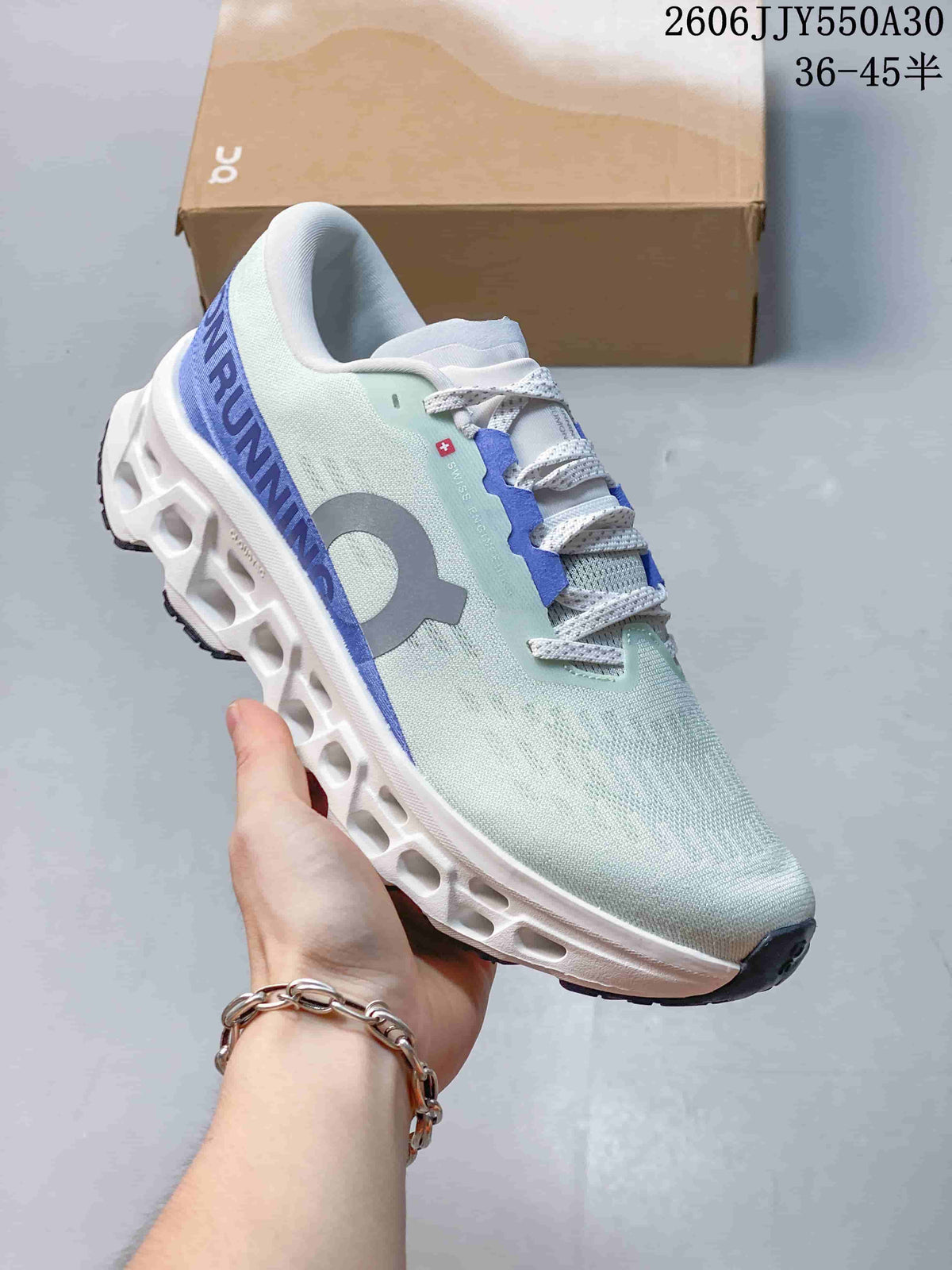 Angled side view of the pale mint and blue running shoe