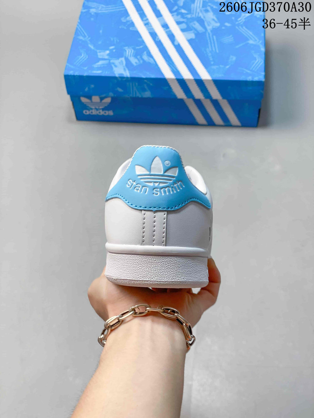 Rear view of the sneaker showing its light-blue heel tab and Stan Smith branding