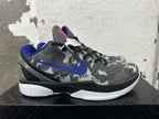 Side view showing blue Swoosh, textured gray camouflage upper, and white midsole