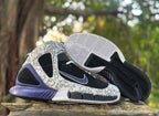 Pair of high-top sneakers with one shoe turned to show the patterned outsole